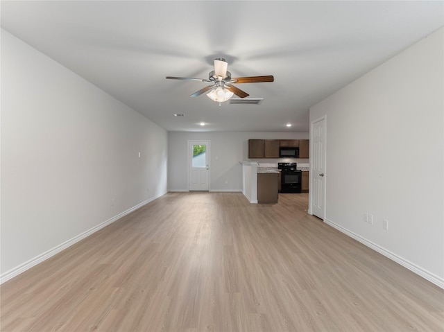 306 N Orange St, Sweeny, TX 77480 - unfurnished living room featuring ceiling fan and light wood-style floors