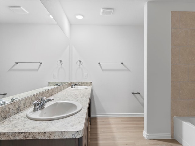 306 N Orange St, Sweeny, TX 77480 - bathroom featuring double vanity and wood finished floors