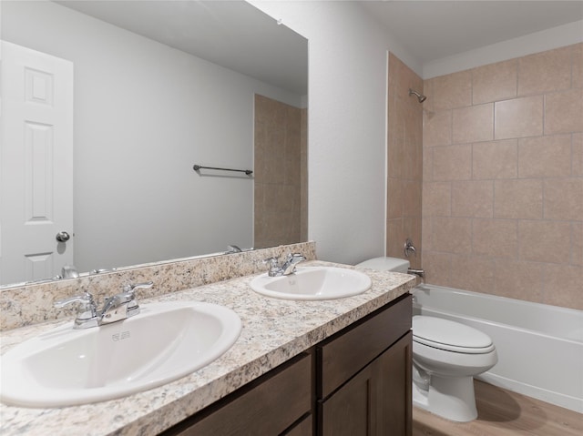 306 N Orange St, Sweeny, TX 77480 - full bathroom featuring double vanity, tub / shower combination, and wood finished floors