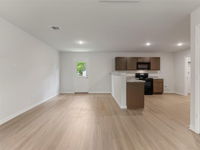 306 N Orange St, Sweeny, TX 77480 - kitchen with black appliances, light wood-type flooring, light countertops, recessed lighting, and open floor plan