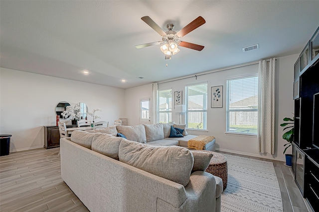 5703 Morning Vista Rd, Katy, TX 77493 - living room featuring healthy amount of natural light, ceiling fan, light wood finished floors, and recessed lighting