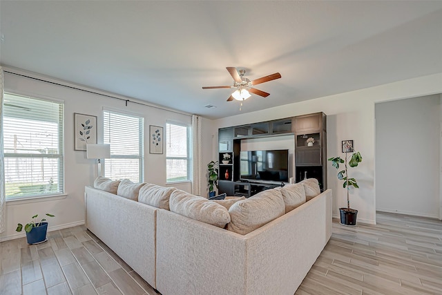 5703 Morning Vista Rd, Katy, TX 77493 - living area with light wood-type flooring, healthy amount of natural light, and a ceiling fan