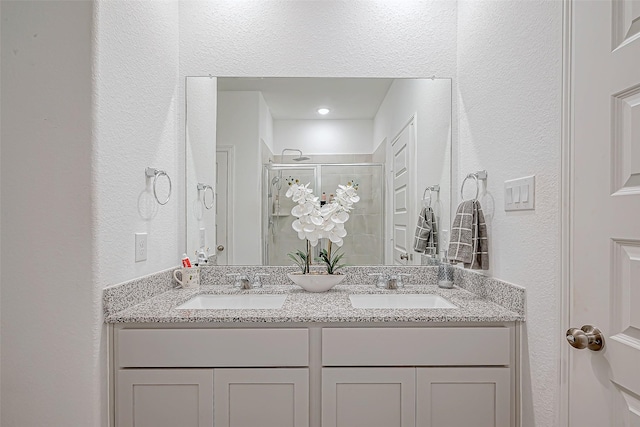 5703 Morning Vista Rd, Katy, TX 77493 - full bathroom featuring a textured wall, a stall shower, and double vanity