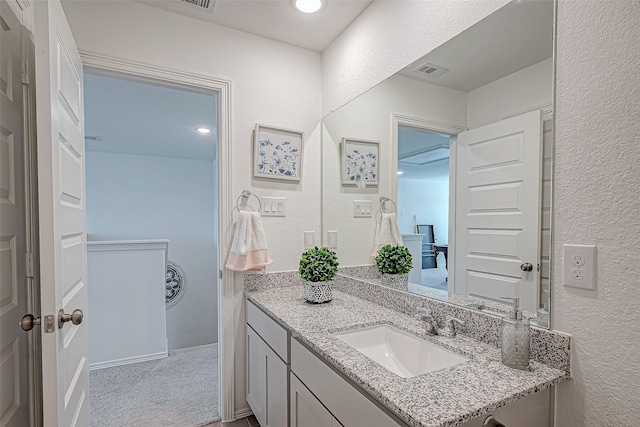 5703 Morning Vista Rd, Katy, TX 77493 - bathroom featuring a textured wall and vanity