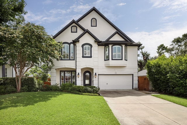 919 Worthshire St, Houston, TX 77008 - french country home featuring a garage, a front lawn, stucco siding, and concrete driveway