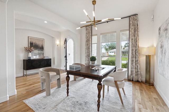 919 Worthshire St, Houston, TX 77008 - dining space featuring light wood-style floors, a chandelier, recessed lighting, and arched walkways