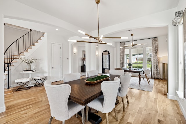919 Worthshire St, Houston, TX 77008 - dining room featuring arched walkways, a chandelier, light wood-type flooring, stairway, and recessed lighting