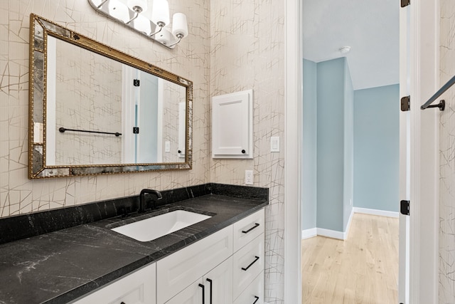 919 Worthshire St, Houston, TX 77008 - bathroom with vanity, wood finished floors, and tasteful backsplash