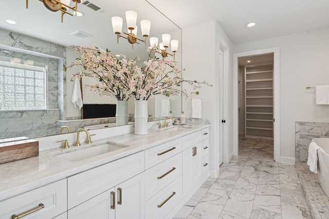 919 Worthshire St, Houston, TX 77008 - full bathroom with a chandelier, marble look tiles, double vanity, a freestanding bath, and recessed lighting