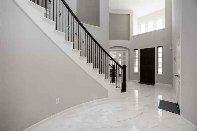 4306 Dalea Clover Ln, Manvel, TX 77578 - entryway featuring marble tiled floors, a towering ceiling, stairway, and arched walkways