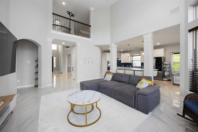 4306 Dalea Clover Ln, Manvel, TX 77578 - living room featuring light marble finish flooring, a towering ceiling, ornate columns, and recessed lighting