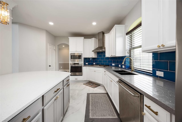 4306 Dalea Clover Ln, Manvel, TX 77578 - kitchen featuring wall chimney exhaust hood, appliances with stainless steel finishes, recessed lighting, light marble finish flooring, and decorative backsplash