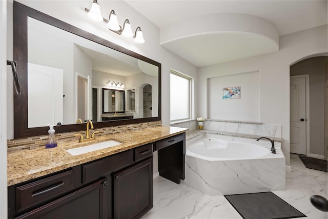4306 Dalea Clover Ln, Manvel, TX 77578 - bathroom featuring vanity, a bath, marble finish floors, and decorative backsplash