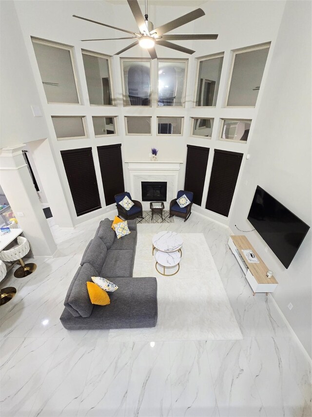 4306 Dalea Clover Ln, Manvel, TX 77578 - living area with a fireplace, marble finish floors, and ceiling fan
