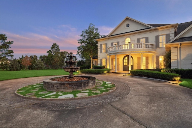 106 Melody Ln, Friendswood, TX 77546 - greek revival house featuring a balcony and curved driveway