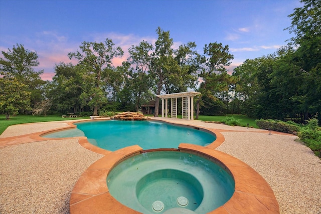 106 Melody Ln, Friendswood, TX 77546 - pool at dusk with a pool with connected hot tub, view of wooded area, and a yard