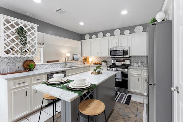 4311 Pebble Beach Dr, League City, TX 77573 - kitchen with appliances with stainless steel finishes, tasteful backsplash, white cabinets, and recessed lighting