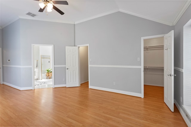 4311 Pebble Beach Dr, League City, TX 77573 - unfurnished bedroom with a walk in closet, light wood-style floors, ornamental molding, ceiling fan, and vaulted ceiling