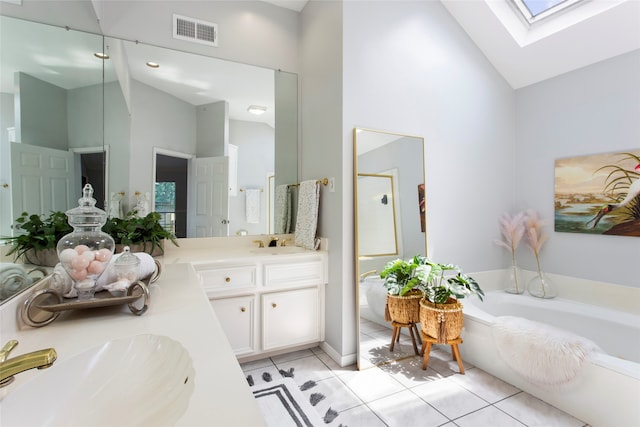 4311 Pebble Beach Dr, League City, TX 77573 - full bath with high vaulted ceiling, a skylight, tile patterned floors, a garden tub, and double vanity