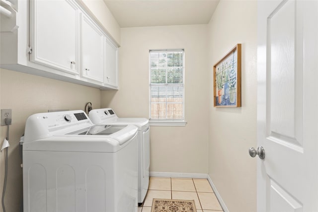 4311 Pebble Beach Dr, League City, TX 77573 - laundry room featuring washing machine and dryer, cabinet space, and light tile patterned floors