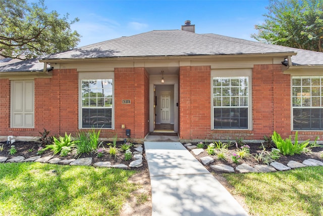 4311 Pebble Beach Dr, League City, TX 77573 - view of front of house with brick siding, a chimney, and a shingled roof