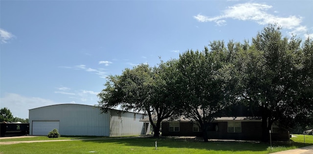 30 Piper Ln, Normangee, TX 77871 - view of green lawn featuring an outdoor structure, an outbuilding, and a detached garage