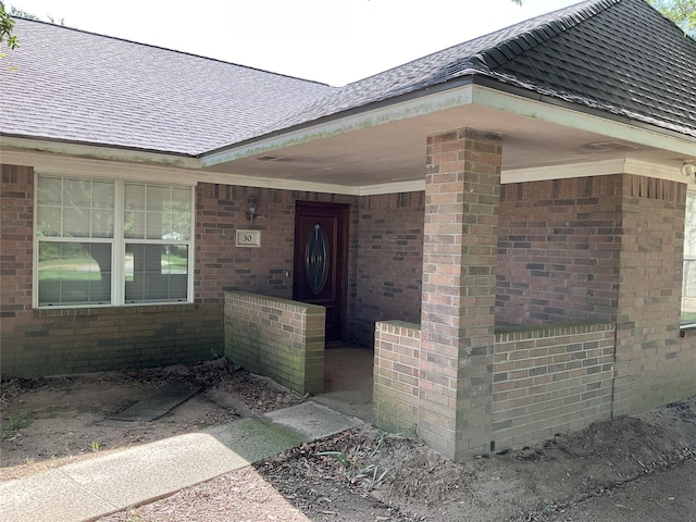 30 Piper Ln, Normangee, TX 77871 - view of exterior entry with brick siding and a shingled roof