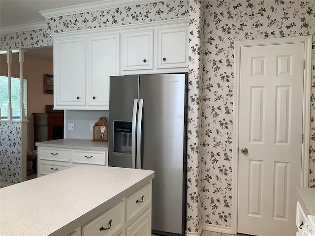 30 Piper Ln, Normangee, TX 77871 - kitchen with stainless steel refrigerator with ice dispenser, wallpapered walls, crown molding, light countertops, and white cabinetry