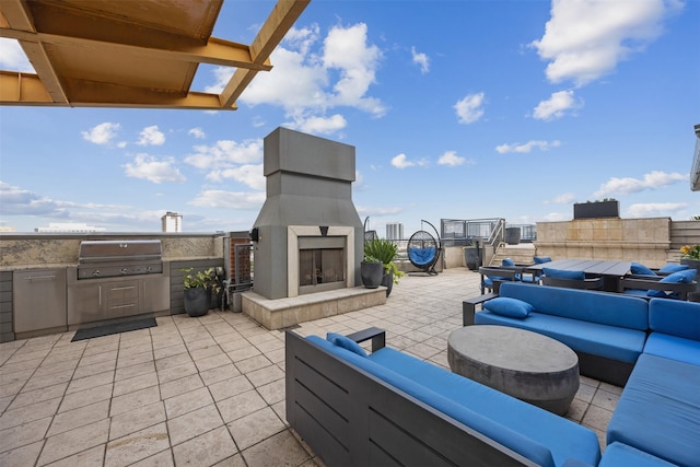 2000 Bagby St Unit 7414, Houston, TX 77002 - view of patio / terrace featuring an outdoor living space with a fireplace and exterior kitchen
