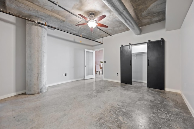 2000 Bagby St Unit 7414, Houston, TX 77002 - unfurnished bedroom featuring concrete floors, a barn door, and ceiling fan