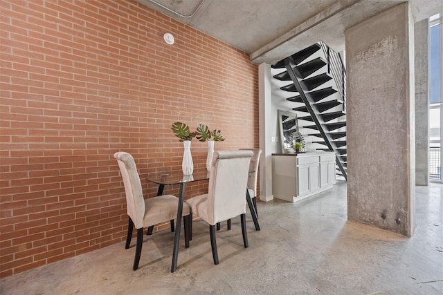 2000 Bagby St Unit 7414, Houston, TX 77002 - dining area featuring concrete flooring and brick wall