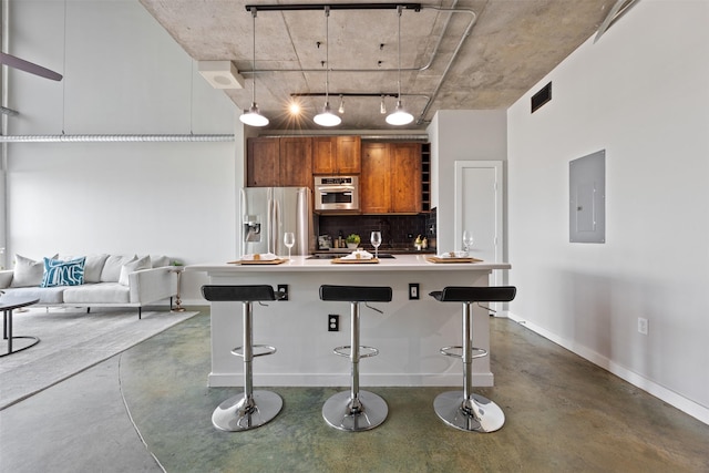 2000 Bagby St Unit 7414, Houston, TX 77002 - kitchen featuring stainless steel refrigerator with ice dispenser, brown cabinets, electric panel, finished concrete floors, and a towering ceiling