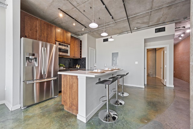 2000 Bagby St Unit 7414, Houston, TX 77002 - kitchen with stainless steel refrigerator with ice dispenser, finished concrete floors, decorative backsplash, and brown cabinets