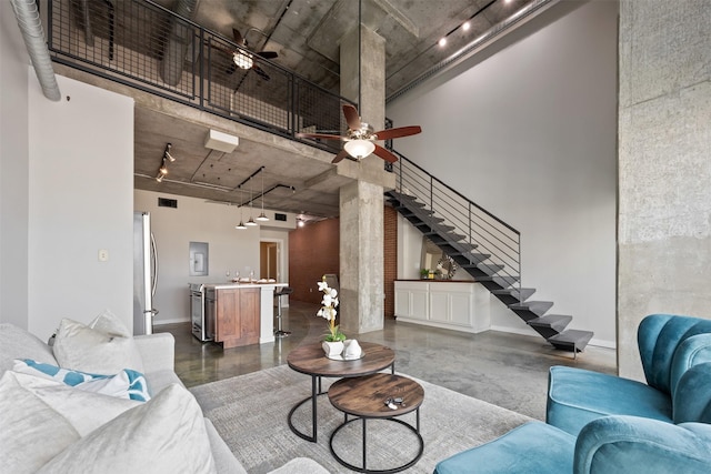 2000 Bagby St Unit 7414, Houston, TX 77002 - living area with rail lighting, stairway, concrete floors, and a towering ceiling