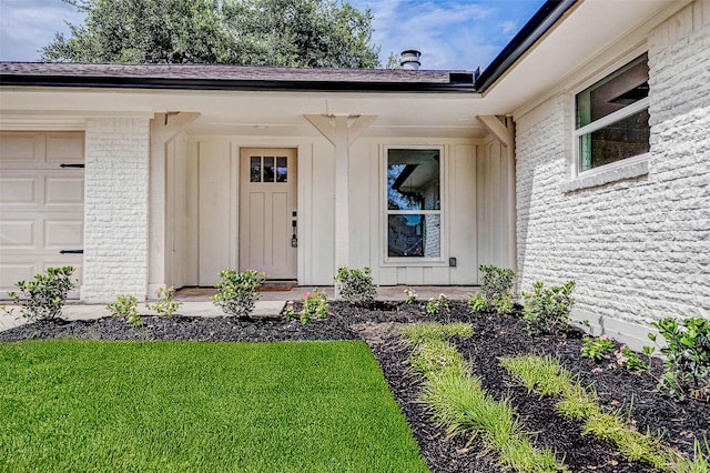 5226 Sanford Rd, Houston, TX 77035 - doorway to property with brick siding, an attached garage, a lawn, and board and batten siding
