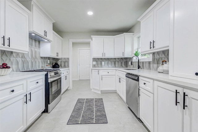 5226 Sanford Rd, Houston, TX 77035 - kitchen featuring stainless steel appliances, backsplash, under cabinet range hood, and recessed lighting