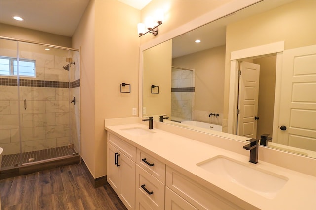 5213 Pinemont Creek Ln, Houston, TX 77018 - full bath featuring a stall shower, double vanity, wood finished floors, recessed lighting, and a bathtub