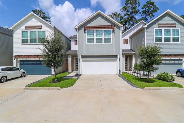 5213 Pinemont Creek Ln, Houston, TX 77018 - view of front facade featuring an attached garage, concrete driveway, and board and batten siding