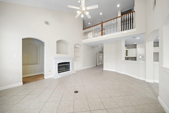 16426 Torry View Ter, Houston, TX 77095 - unfurnished living room with a high ceiling, built in features, ceiling fan, light tile patterned floors, and recessed lighting