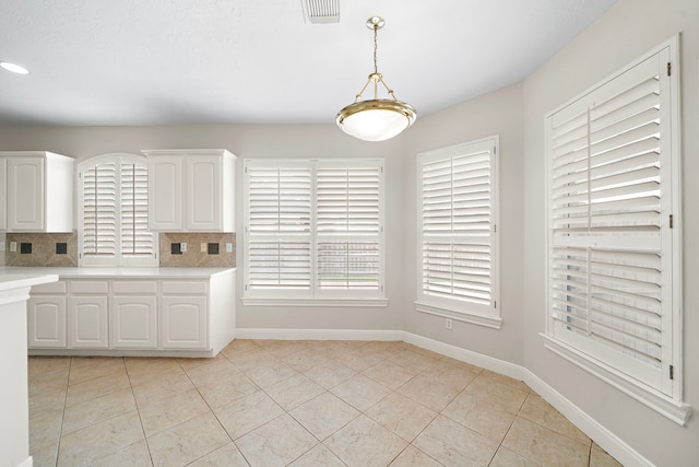 16426 Torry View Ter, Houston, TX 77095 - kitchen with light countertops, tasteful backsplash, white cabinets, and light tile patterned flooring