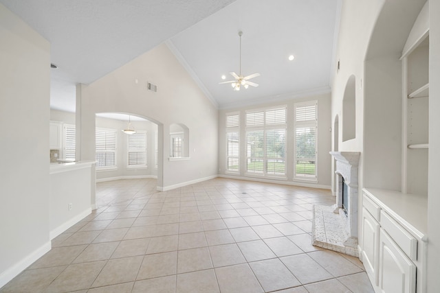 16426 Torry View Ter, Houston, TX 77095 - unfurnished living room with a ceiling fan, light tile patterned flooring, a fireplace, high vaulted ceiling, and crown molding