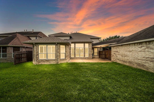 16426 Torry View Ter, Houston, TX 77095 - back of property at dusk featuring a patio, brick siding, and a shingled roof