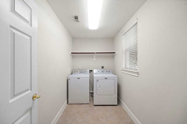 16426 Torry View Ter, Houston, TX 77095 - laundry area with washer and dryer and light tile patterned flooring