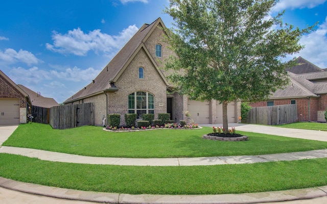 3605 Dolan Trail Ct, Pearland, TX 77584 - french country inspired facade featuring brick siding, concrete driveway, roof with shingles, and a gate