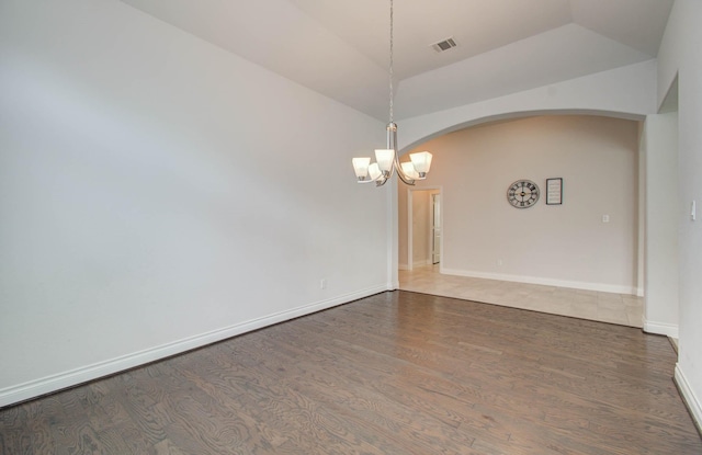 3605 Dolan Trail Ct, Pearland, TX 77584 - spare room with arched walkways, a chandelier, lofted ceiling, and wood finished floors