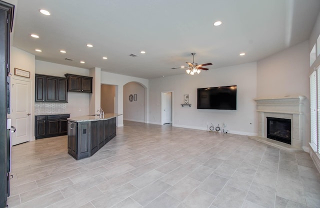 3605 Dolan Trail Ct, Pearland, TX 77584 - kitchen featuring open floor plan, a ceiling fan, arched walkways, recessed lighting, and tasteful backsplash