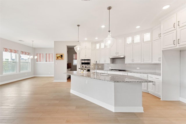 14315 Summer Prairie Trl, Cypress, TX 77433 - kitchen with recessed lighting, white cabinets, backsplash, glass insert cabinets, and a center island with sink
