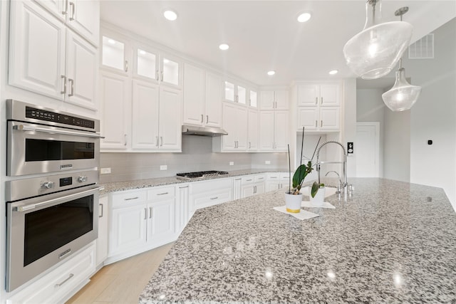 14315 Summer Prairie Trl, Cypress, TX 77433 - kitchen with appliances with stainless steel finishes, white cabinetry, light stone counters, and recessed lighting