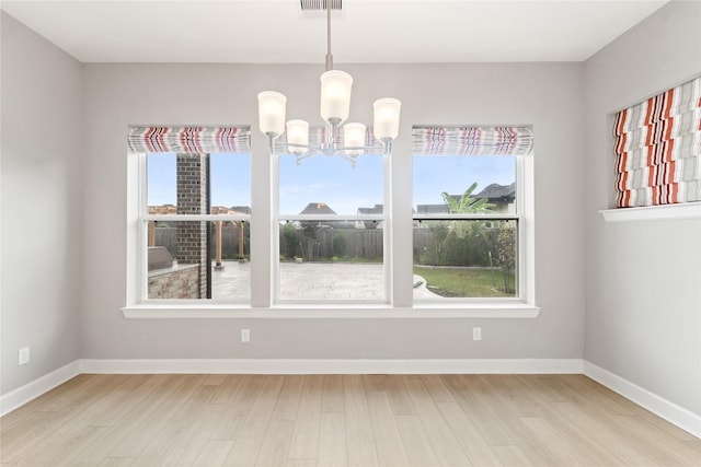 14315 Summer Prairie Trl, Cypress, TX 77433 - empty room with a chandelier, healthy amount of natural light, and light wood finished floors