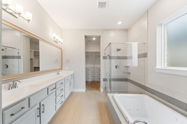 14315 Summer Prairie Trl, Cypress, TX 77433 - full bathroom with a shower stall, a spacious closet, double vanity, a whirlpool tub, and recessed lighting